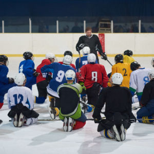 ice hockey players team group meeting with trainer  in sport arena indoors